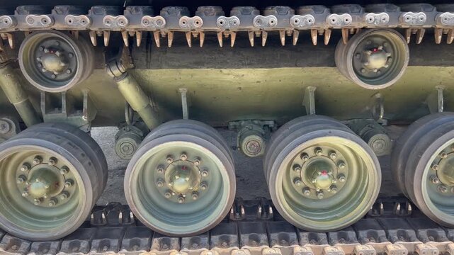 THAILAND - AUGUST 9, 2026: Heavy military battle tank operating in field training grounds, showing external armor tracks and interior tactical command cockpit equipment inside a restricted m