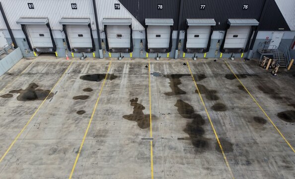 Empty loading dock doors with puddles on concrete