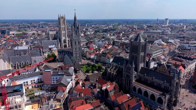 Aerial view video clip of Three Towers of Ghent, St Nicholas Church, Belfry of Ghent, St Bavo Cathedral, historic rooftops, and city panorama in East Flanders, Belgium