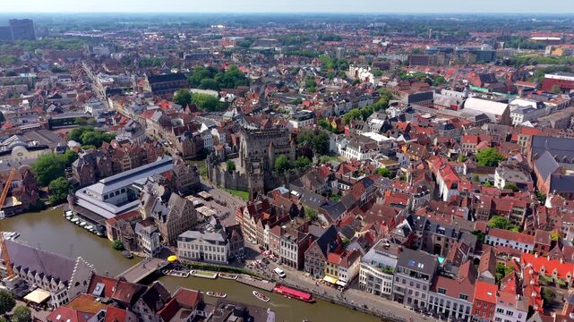 Aerial view video clip of Gravensteen Castle, Korenlei and Graslei canals, Leie river, historic guild houses, and city panorama in Ghent, East Flanders, Belgium
