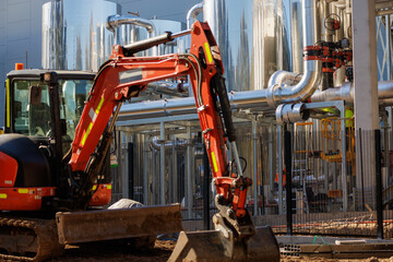 Fototapeta premium Data center construction site with excavator and cooling plant