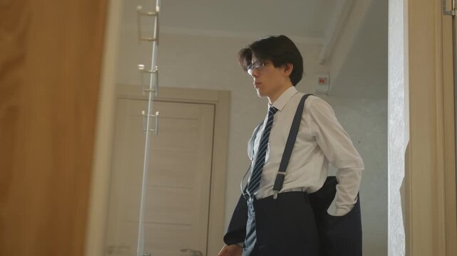 Candidate readies for important interview. Young professional practices confidence before meeting. Determined young professional adjusts appearance and gathers composure before crucial interview