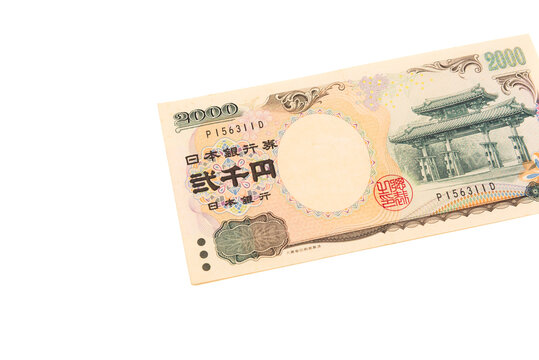 Top view of the front side of a rare 2,000 Japanese yen banknote, featuring the Shureimon gate. Scarce currency, isolated on white background. Finance and collectibles.