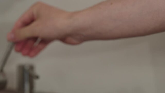 Slow motion man hand wash fresh ripe blueberry