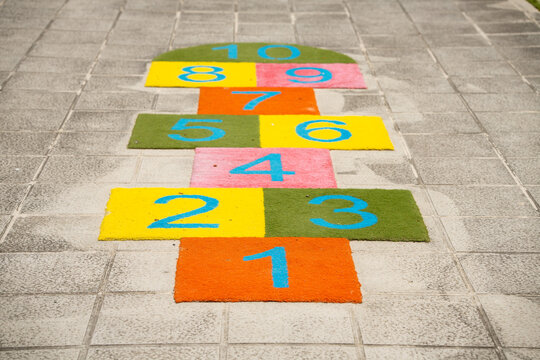 Colorful numbers from 1 to 10 painted on a sidewalk for a children's hopscotch game