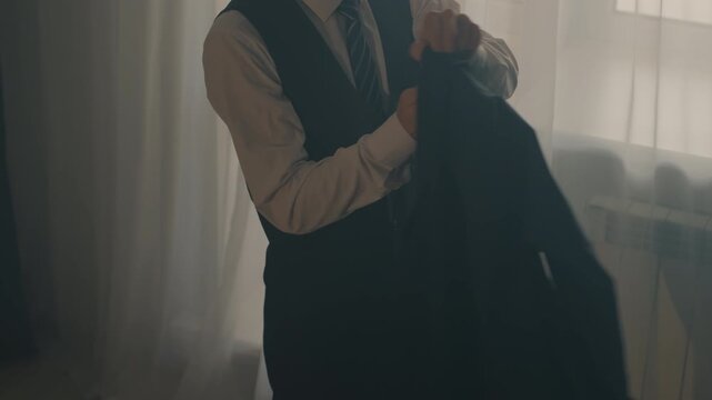 Asian student putting on jacket near window, adjusting tie with focused nervous expression, soft backlight through sheer curtains, minimalist room with chair and vest, warm filmic tones, intimate