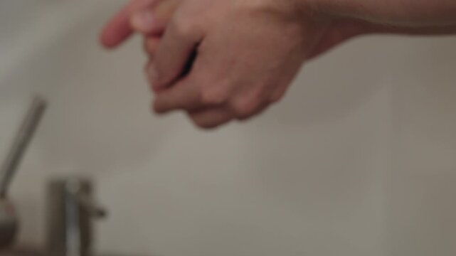 Slow motion man hand wash fresh ripe blueberry