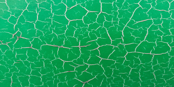close up broken surface of deteriorating green tennis court floor. background and sports concept.