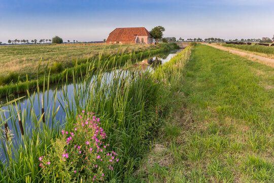 Little river and farm in the landscape of Groningen