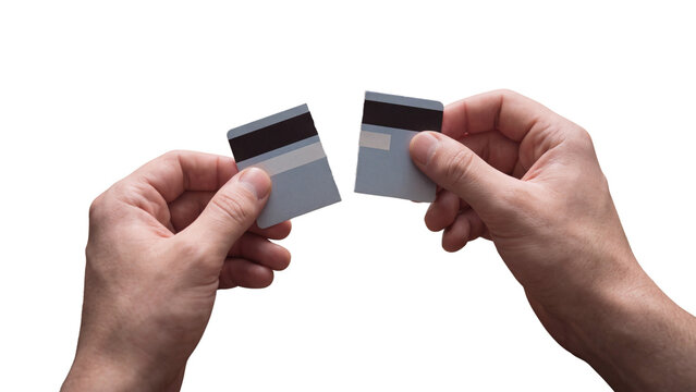 Man hands holding torn credit card on transparent background. Concept of debt freedom, financial planning and budget control. Cutting card for ending loan and avoiding consumer spending.