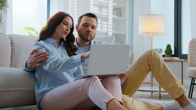 Caucasian with laptop app choosing furniture clothes online at home family man with woman talking choose food products delivery in internet market with computer talk browsing web store at home