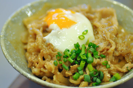Rice topped with stir fried pork or stir fried beef and egg or Japanese food or Korean food or Beef Rice Bowl , Gyudon
