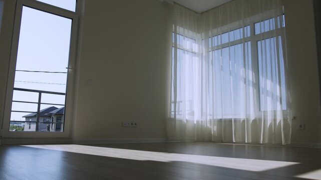 Empty modern room with large windows and sunlight in residential house