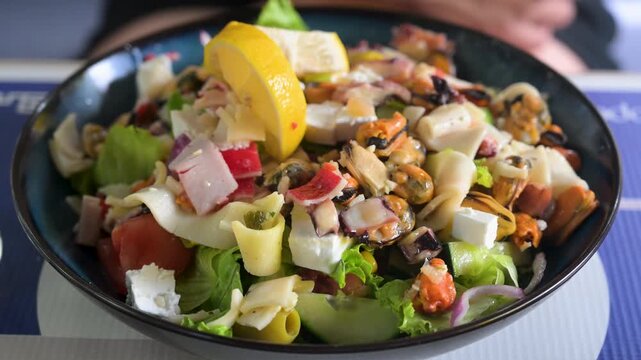 Fresh seafood salad served on a restaurant table. Gourmet seafood salad ready to eat in a restaurant.