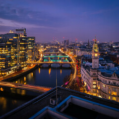 Fototapeta premium Dublin City Skyline at Dusk with River, Bridges and Illuminated Urban Buildings