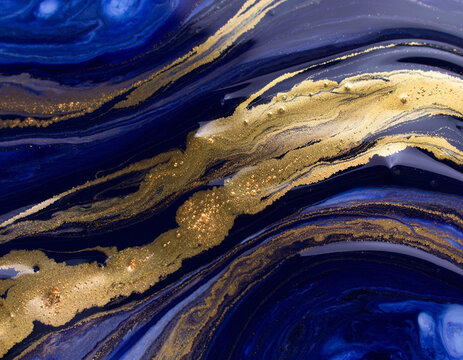 Blue and gold fluid art painting with marble swirls and glittering texture