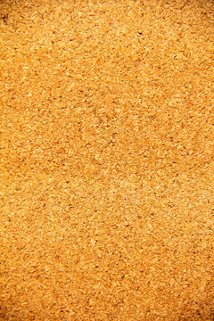 Brown rice grains spread out on a flat surface for drying in the sunlight