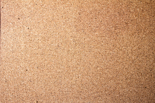 Cork board surface used for notes and reminders in an office or classroom setting