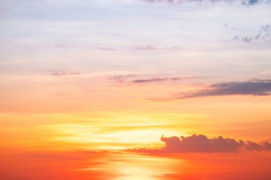 Sky sunset,Beautiful sunrise sky with vibrant gradient orange and gold colors and soft blue, Clear atmosphere with wispy clouds. Peaceful, perfect for background and copy space, High resolution images