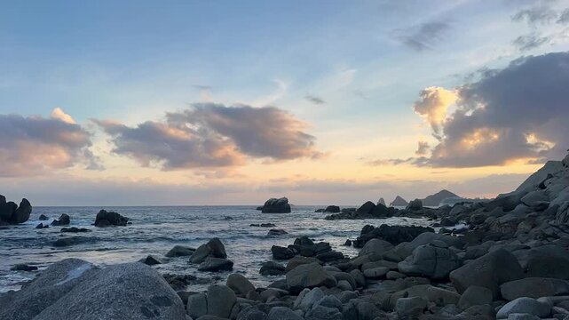stunning view to the famous arch of cabo san lucas and rocky beach at sunset
