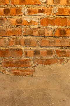 Brick wall with mortar and plaster details in an indoor space