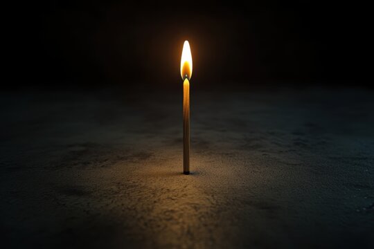 Lit wooden matchstick dark background minimal still life single flame vertical match isolated object warm light copy space