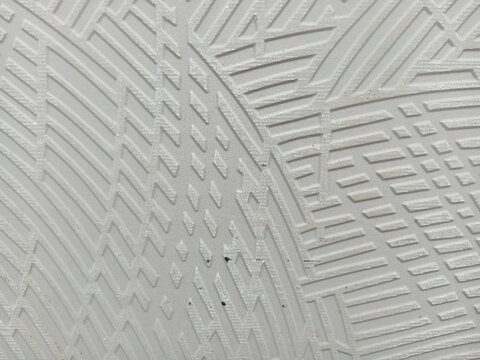 White abstract textured surface with geometric engraved linear patterns
