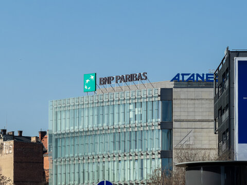 Poznan, Poland - February 28, 2026: BNP Paribas logo atop a modern glass office building against a clear blue sky, representing global corporate finance and professional banking