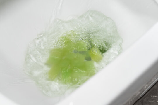 Test the toilet's flushing ability by dropping an object into it.