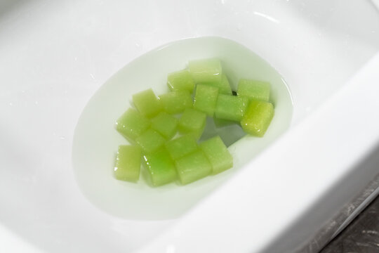 Test the toilet's flushing ability by dropping an object into it.