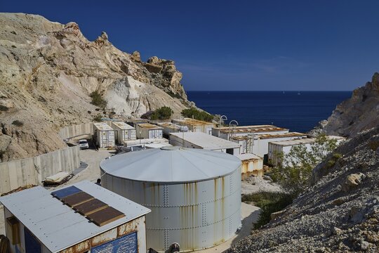 Seawater desalination plant, desalination plant on the coast surrounded by rocky landscape under clear blue sky, volcanic island, island, Milos, Cyclades, Greek Islands, Greece