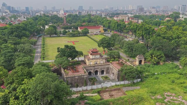 Aerial footage of the Imperial Citadel of Thang Long, a UNESCO World Heritage landmark surrounded by gardens, historic architecture, and the Hanoi city skyline.