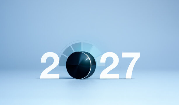 A control dial replaces zero in 2027 against a clean blue background, representing performance optimization, KPI monitoring, efficiency adjustment, strategic planning and business growth concept.