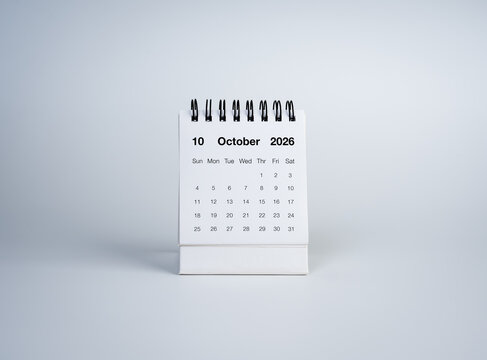 Minimal desktop calendar displaying October 2026 on a clean white background, representing schedule planning, time management, business organization, monthly planning, important dates with copy space.