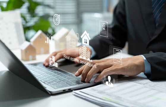 Real estate developer using laptop with digital property technology, housing investment, financial analytics and project management icons for modern residential development and business planning.