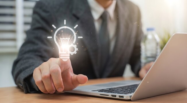Businessman pointing at glowing lightbulb and gear hologram for innovation and idea concept