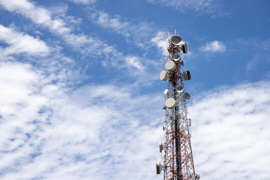 Telecommunication tower with antennas against blue sky