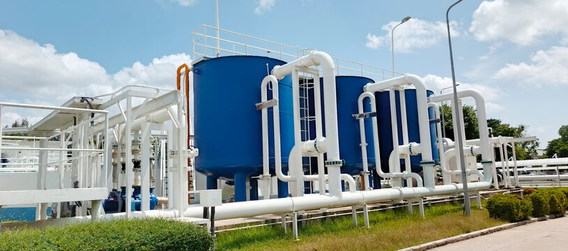 Modern Industrial Water Treatment Facility with Blue Filtration Tanks and Pipeline Network