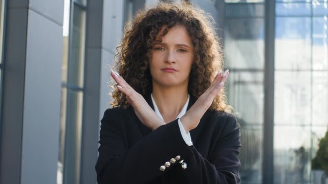 Portrait Caucasian serious confident business woman crossing hands never no protest gesture girl female businesswoman agent cross arms showing stop reject denied looking at camera in city near office