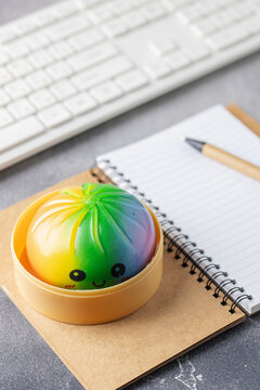 Cute pastel dumpling squishy toy held on the table. Trendy anti stress toy