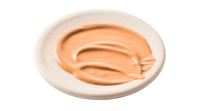 Beige cream concealer or bb cream sample on white plate isolated on PNG transparent background