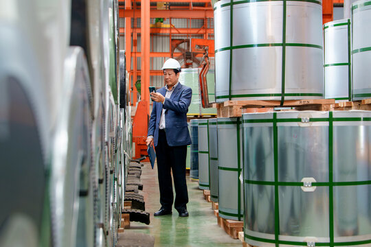 Warehouse Manager Using Smartphone to Oversee Inventory Control of Metal Coils in Manufacturing Setting