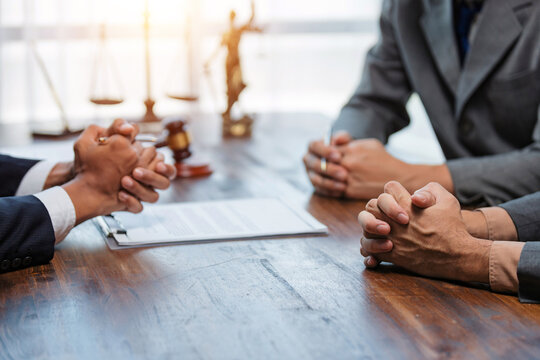 Lawyers consulting clients on legal contract and justice