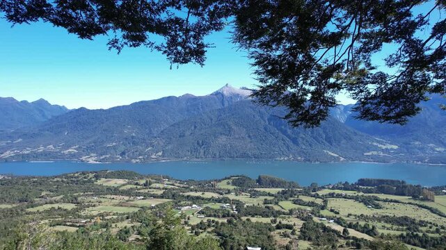 Aerial View Of Cochamo Valley With Woman Swinging On Tree Rope Swing, Chile