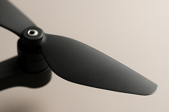 Close up of black drone propeller blade on neutral background