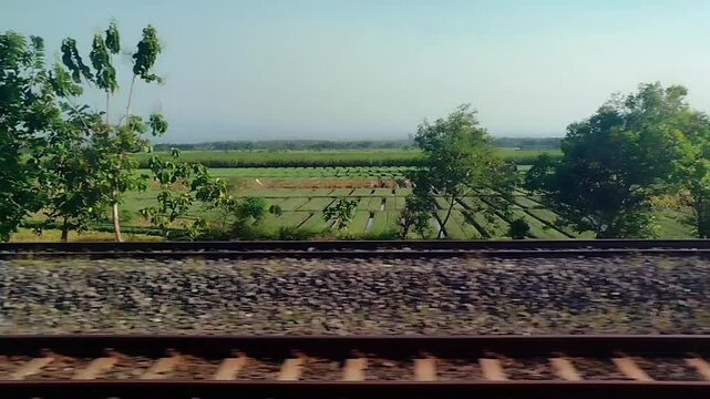 Sunset view outside the window from a moving train. traveling by train transportation