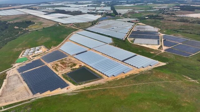 Overview of greenhouse complex featuring polytunnel farms and solar panels