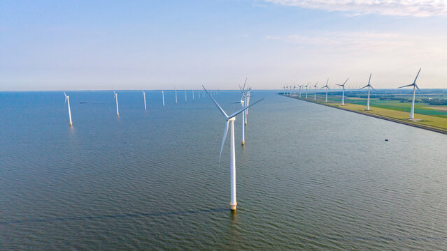 Breathtaking windmill park overlooking the serene waters in Tollebeek, Flevoland, Netherlands