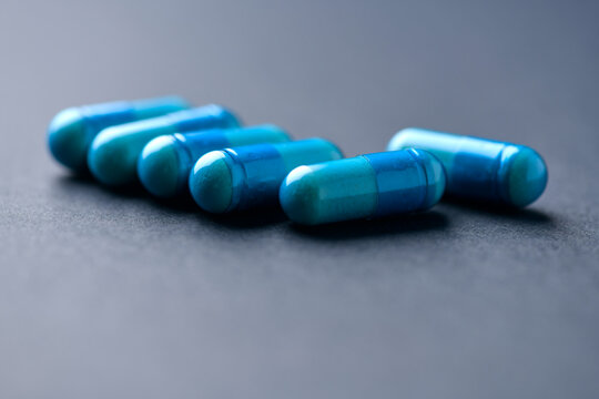 Amino acids capsules on paper background. Soft focus. Close up