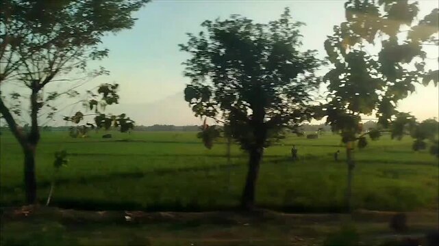 Sunset view outside the window from a moving train. traveling by train transportation